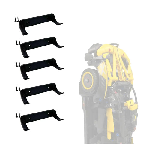 Four black wall mounting brackets with screws by Chatelet Manufacturing are shown left, and a folded yellow and black Lego Technic racecar mounted vertically right—ideal for displaying your collectible cars with the Vertical Collectible Car Wall Display Mount.
