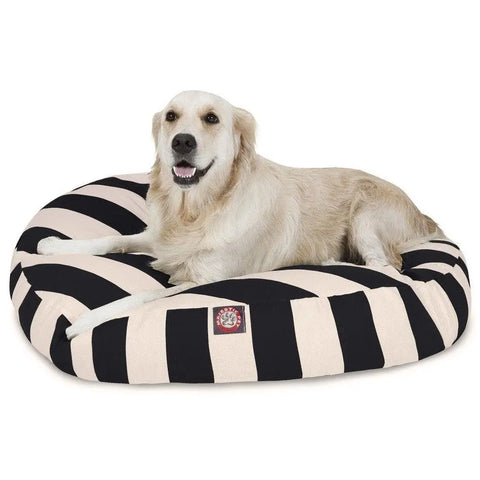 A golden retriever relaxes on the Majestic Pet Vertical Stripe Round Dog Bed, featuring wide black and white stripes. Its washable, removable cover keeps the bed fresh and clean.