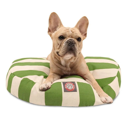 A light brown French Bulldog lies on a Majestic Pet Vertical Stripe Round Dog Bed with a removable, washable cover, looking forward with its ears perked up.