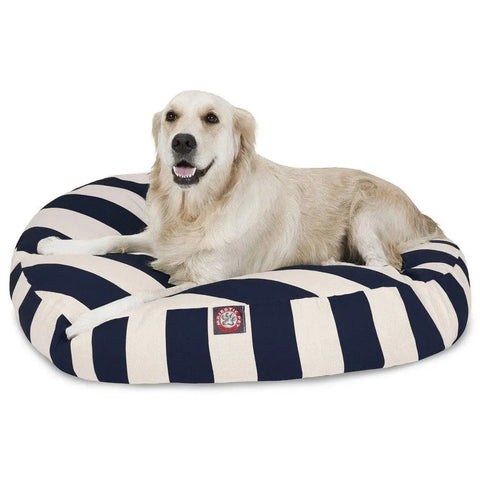 A golden retriever relaxes on the Majestic Pet Vertical Stripe Round Dog Bed, featuring wide navy blue and white stripes and a removable, washable cover for easy cleaning.