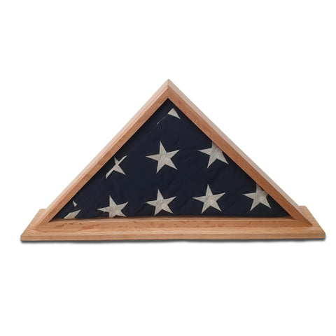 The Legacies of America Woodworking Company Oak Burial Flag Display Case (for 5 x 9.5 flags) showcases a folded American flag with white stars, crafted from oak hardwood with a flat base. Made in the USA to honor military service.