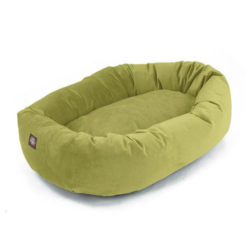 The Majestic Pet Villa Bagel Dog Bed is a soft, oval green bed with raised sides and a plush polyester micro-velvet cushion filled with shredded memory foam. Machine washable for easy care. Displayed on a white background.