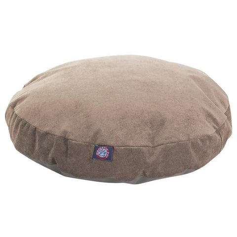 The Villa Round Dog Bed by Majestic Pet is a round, brown suede pet bed featuring a small stitched brand logo tag on the front and a removable, washable cover, shown against a white background.