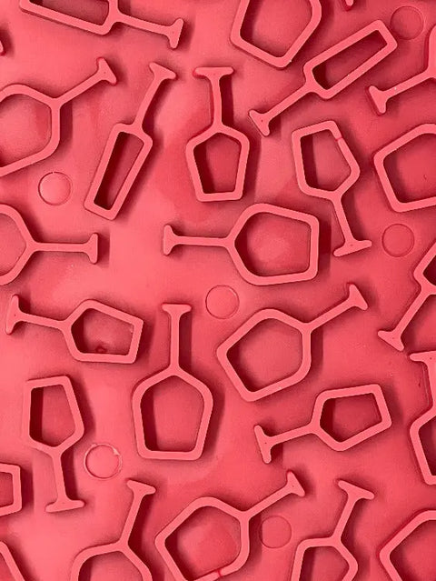 The SodaPup Vino Design EMat Enrichment Lick Mat features repeated, multi-directional wine glass shapes on a red silicone background—ideal for creative enrichment for any pet owner.