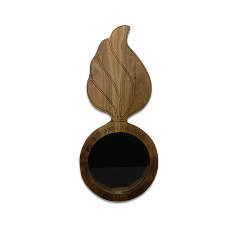 The Legacies of America Woodworking Company Walnut Ammo Pisspot Shadow Box is a circular walnut plaque with a large leaf on top, engraved “PARLIAMENT FOR PEACE” around the edge. Made in the USA.