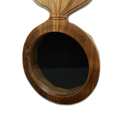 The Walnut Ammo Pisspot Shadow Box by Legacies of America Woodworking Company is a bomb-shaped walnut case with a glass front, ARMAMENT FOR PEACE engraved, white background, and built by veterans.