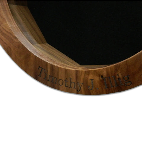 Close-up of a Walnut Ammo Pisspot Shadow Box by Legacies of America Woodworking Company, engraved with Timothy J. Illig on its surface. The piece shows a black background inside. Proudly Made in the USA.