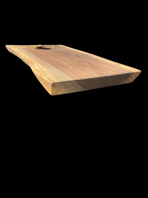 The Walnut Live Edge Serving Tray by B. James Design & Woodwork is shown at an angle against a black background, highlighting its rich walnut grain, smooth texture, and unique handcrafted live edge design.