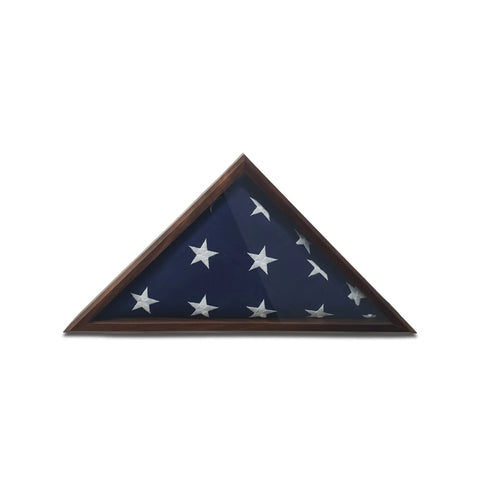 A folded American flag with white stars is showcased inside the Legacies of America Woodworking Company Walnut 4x6 Flag Display Case, a triangular wooden case, against a plain white background.