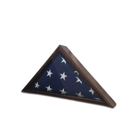 The Legacies of America Woodworking Company Walnut 4x6 Flag Display Case is a triangular wooden case with a glass front, designed to display a folded American Flag with white stars as a memorial or keepsake.