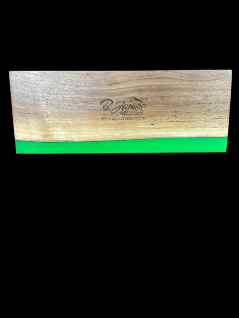 The Lime Green Epoxy Walnut Cribbage Board by B. James Design & Woodwork features a green resin bottom edge, engraved logo, center text B. James Design, and website URL, highlighting its handcrafted quality.