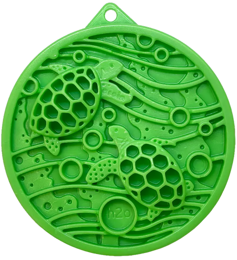 The SodaPup Water Nylon ECoin Durable Enrichment Snacking Coin is a green, circular medallion with two sea turtles, honeycomb shells, wave and bubble patterns. Use as a peanut butter holder for problem chewing. H2O embossed at bottom; includes hanging hole.