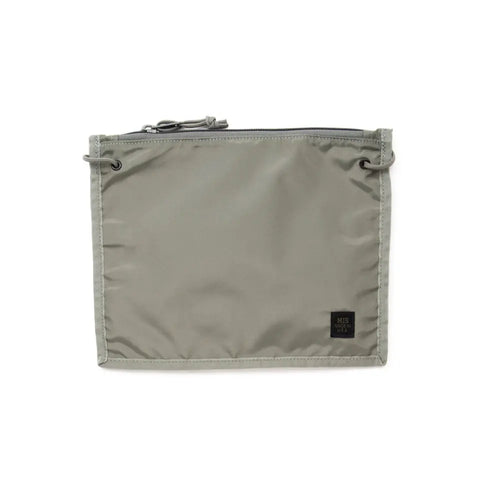 The MIS 2 Way Pouch - Foliage is a rectangular, light gray zippered pouch made from durable packcloth nylon with metal grommets on each corner and a small black fabric label at the bottom right.