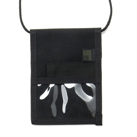 The MIS ID Passport Case - Black is a water-resistant Cordura nylon neck wallet with a clear front pocket, horizontal strap, and a small rectangular patch in the top right corner—perfect for securely holding your passport.
