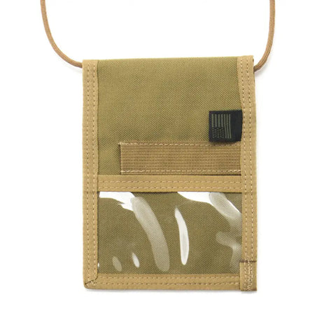 The MIS ID Passport Case in Coyote Tan features durable Cordura nylon, a transparent front pocket, fabric pocket above, small rectangular tag, and attached tan cord—ideal for organizing travel documents or holding your passport.