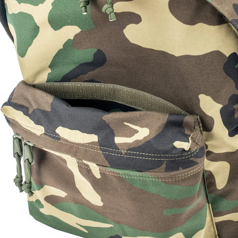 Close-up of the MIS Daypack Goretex in Woodland Camo, a waterproof nylon backpack with green, brown, beige, and black camouflage pattern, open front pocket, and visible stitching.