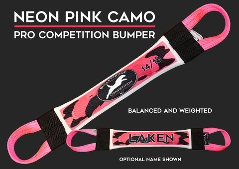 The Bulletproof Pet Products Inc Dock Diving Bumper Tug – Competition Series Weighted in Neon Pink Camo features black end grips, a central logo, and optional custom name (e.g., LAKEN). Highlights: NEON PINK CAMO, BALANCED AND WEIGHTED, OPTIONAL NAME.