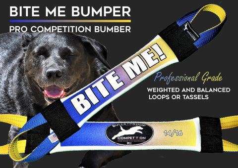 A happy black dog stands with eyes closed behind the Bulletproof Pet Products Inc Dock Diving Bumper Tug – Competition Series Weighted – Bite Me Ombre, featuring blue, yellow, and white ombre colors, loops, and “BITE ME!” text.
