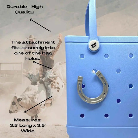 Close-up of a blue tote bag featuring Chatelet Manufacturing’s BOGLETS - RODEO Charms and a letter b button, labeled to show the charm’s durability, secure attachment, and size. A blurred cowboy on a bull is visible in the background.