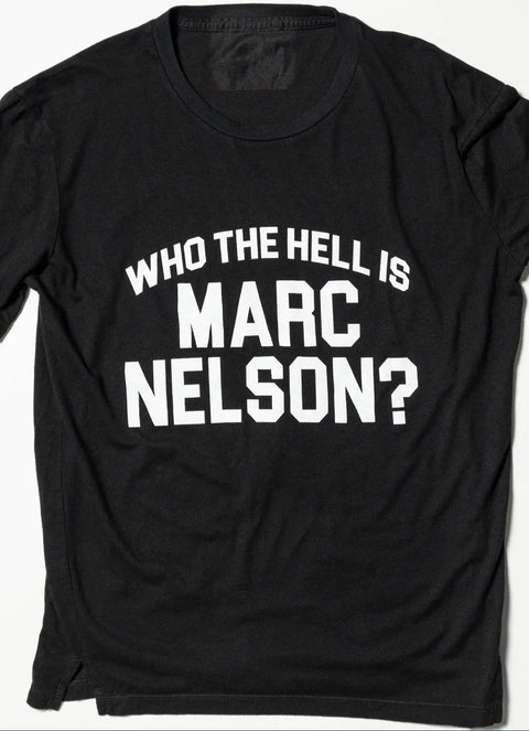 The Marc Nelson Who the Hell? Tee is a black, classic fit shirt made from premium cotton, featuring bold white text: WHO THE HELL IS MARC NELSON? for lasting comfort and standout style.