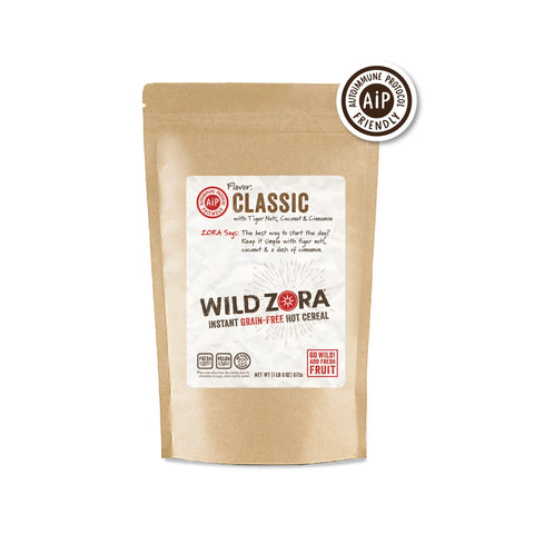 A brown resealable pouch of Wild Zora Instant Cereal - AIP Classic With Tiger Nuts, Coconut & Cinnamon 5-Pack features a white label and AIP-friendly badge, with ingredients like tiger nuts, coconut, and cinnamon for the autoimmune protocol diet.