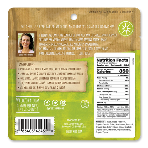 Back of the Wild Zora Meals to Go - All Flavors Variety 7-Pack shows prep instructions, nutrition facts, ingredients (grass-fed beef), company info, social media handles, barcode, and a founder story with photo. Packaging is mostly yellow and brown.