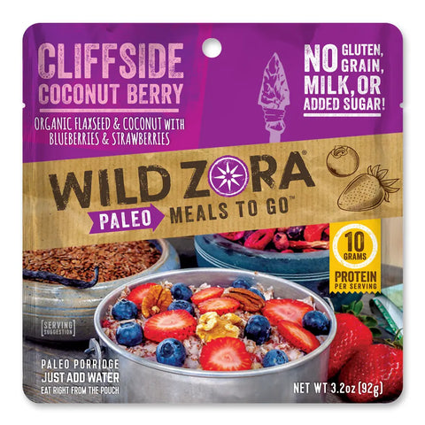 Wild Zora Meals to Go - Cliffside Coconut Berry (Vegan) comes in a single-serve pouch. The package shows berry porridge with blueberries and strawberries, and notes its high in protein with no gluten, grain, milk, or added sugar.