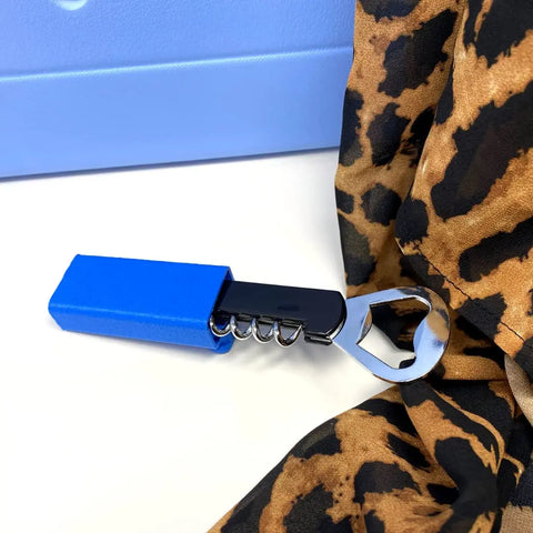 The BOGLETS Wine & Bottle Opener Charm Accessory by Chatelet Manufacturing is a blue corkscrew designed for Bogg Bags—keep your wine opener handy and add charm to your tote wherever you go.