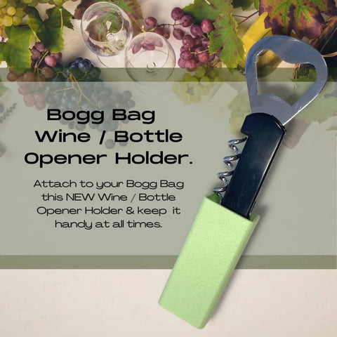 A Chatelet Manufacturing BOGLETS wine & bottle opener charm accessory for Bogg Bags, with a green handle, sits on a beige surface with grapes and leaves—ideal for keeping your opener handy and organized on your tote.