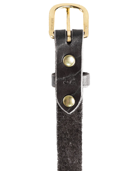 A close-up of Homestead Brands Womens Essential Belt No. 1509 shows black textured leather with a solid brass buckle and two brass rivets. Made in the U.S.A., this durable belt offers timeless style.