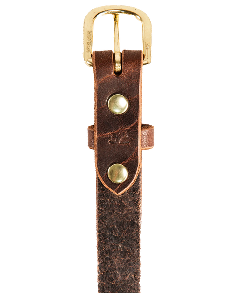 Close-up of Homestead Brand Womens Essential Belt No. 1509, made in the U.S.A., with a gold solid brass buckle and two brass rivets. The textured leather displays rugged wear, shown against a white background.