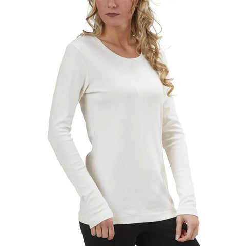 A woman with long, wavy blonde hair wears the Spiritex Long Sleeve Perfect Crewneck Tee (W) with black pants, standing against a white background. Her face is partially visible and her arms rest at her sides.