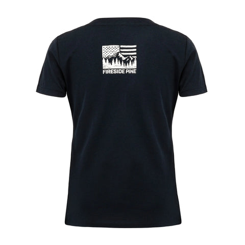 A blue Oregon Ash T-shirt by Fireside Pine, made in the USA, is shown from the back with a small white graphic near the neck featuring an American flag, pine trees, and “FIRESIDE PINE” below.