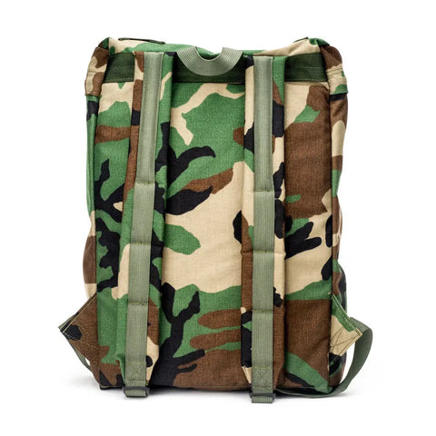 The MIS Backpack - Woodland Camo is made of Cordura Nylon and features a classic woodland camo pattern, green adjustable shoulder straps, and a padded laptop holder. Shown from the back against a white background.