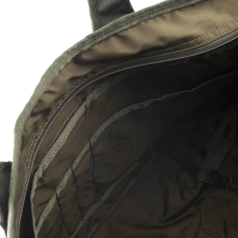 Close-up of the inside of the MIS Tote Bag - Woodland Camo, featuring its Cordura nylon lining, sturdy seams, and a zippered pocket. Made in USA.