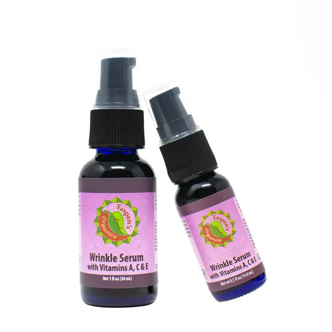 Two bottles of Taspens Organics Wrinkle Facial Serum With A, C & E are displayed on a white background—one upright, one tilted—with purple labels and black pump tops, ideal for hydrating your skin.