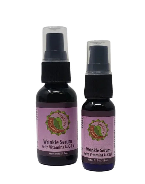 Two bottles of Taspens Organics Wrinkle Facial Serum With A, C & E, both with purple labels and pump dispensers. One bottle is larger than the other.