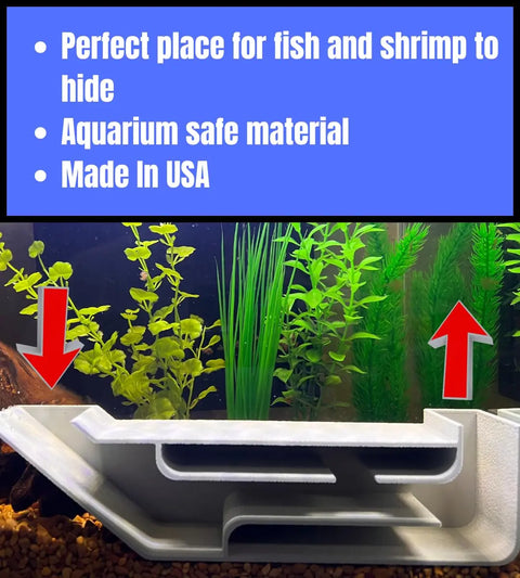 The Chatelet REEFSHAPE X-Large Underground Tunnel by Chatelet Manufacturing sits on gravel among green plants. Red arrows highlight this USA-made, aquarium-safe fish and shrimp hideout, crafted for safety with multiple hiding spaces.