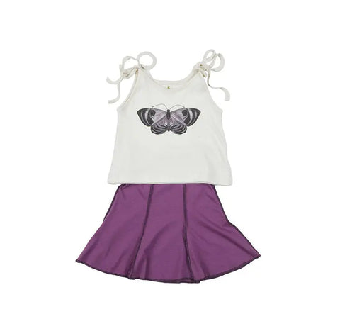 The Spiritex Youth Graphic Butterfly Crop Tie Tank, a sleeveless white organic top with tie straps and butterfly graphic, is paired with a purple flared skirt. Both are laid flat on a white background—ideal for sensitive skin and comfy summer outfits.