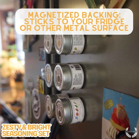Six Gustus Vitae Zesty & Bright Citrus Seasoning tins, each with a magnetic back, are displayed on a fridge door. Their labels face out among colorful magnets and notes. This handcrafted 6-pack spice set is made in the USA.