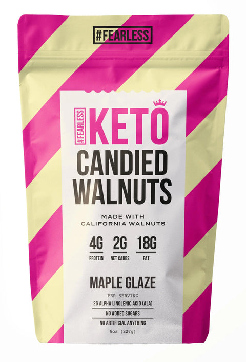 Fearless Keto Candied Walnuts - Maple Glaze offer 4g protein, 2g net carbs, and 18g fat per serving. This low-carb snack has no added sugars and comes in a pink and beige bag with bold text and a #FEARLESS label at the top.