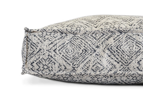A close-up of The Houndry Lounger Pet Bed in Sapphire Spaniel shows its black and white geometric diamond patterned fabric, visible edge stitching, and raised seams—a stylish, practical, and washable option for your pet.
