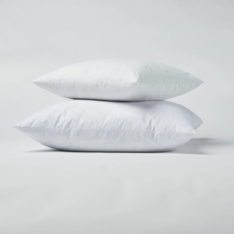 The Down Decor Pillow Inserts - Set of 2 are stacked atop one another against a plain, light gray background.